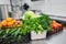 Fresh colorful Vegetables and fruit in kitchen on silver steel table. Work surface and kitchen equipment in professional