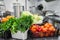 Fresh colorful Vegetables and fruit in kitchen on silver steel table. Work surface and kitchen equipment in professional