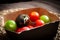 Fresh, colourful red, green, yellow and purple tomatoes served on a rustic dish.