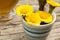 Fresh coltsfoot Tussilago farfara flowers in a cup