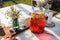 Fresh compote, fruits, candles and flowers on wooden table closeup. Selective focus. Beutiful decoration in boho style.