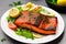 Fresh cooked delicious salmon steak with salad lemon potato