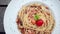 Fresh, cooked pasta with sauce, parsley, served on a plate. Top view of decorated table with tomatoes and parmesan on a