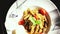 Fresh, cooked pasta, served on a plate. Top view of decorated plate with tomatoes, garlic,basil leaves, parmesan and