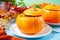 Fresh cooked pumpkin soup served in a pumpkin. Autumn warm and cozy food