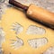 Fresh cookie dough and rolling pin with hands and feet cutout, c
