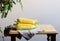 Fresh corn cobs with leaves on a wooden table over grey wall background. Raw corncobs on light brown wooden table, rustic style.