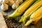 Fresh corn on cobs on rustic wooden table, closeup