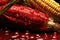 Fresh corn with drops of blood on dark background, closeup view, imagine Recreation artistic of cobs corn in a maizefield with red