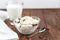 Fresh cottage cheese in a transparent bowl with raisins. In the background is a glass of kefir. Fermented foods. Good bacteria for