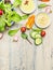 Fresh country salad preparation with organic garden vegetables on light rustic kitchen table, top view, place for text.