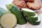 Fresh courgette or zucchini close up view, with fitters in the background