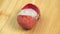 Fresh cracked lychee fruit in shell rotate in macro on wooden background. Lychee berries for making lemonade and