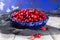 Fresh cranberries in a blue bowl. Ripe berries of Vaccinium macrocarpon, also large cranberry, American cranberry or bearberry.