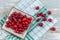 Fresh cranberries fruits in rustic asian bowl on old green wooden Background and daylight