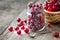 Fresh cranberries with sugar in jar, basket with berries