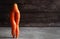 fresh creative carrots in the form of legs on a wooden background