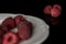 Fresh crimson raspberry  on black glass