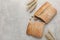 Fresh crispy ciabatta and spikelets on grey table, flat lay. Space for text