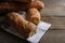 Fresh crispy ciabattas on wooden table, closeup