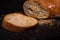 Fresh crispy sliced bread on a black background with copy space. Food background