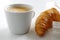 Fresh Croissant and cup of coffee