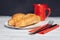 fresh croissant on a plate kitchen utensils coffee cup breakfast