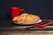 fresh croissant on a plate kitchen utensils coffee cup breakfast