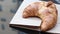 Fresh croissant on the table in the open air cafe