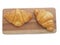 Fresh croissants bread on wood plate isolated on white background