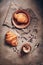 Fresh croissants and hot coffee with froth on a dark rustic background. Top view, flat lay. Traditional French pastries