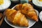 Fresh croissants on a plate, breakfast idea