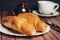 fresh croissants on a saucer table setting breakfast