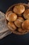 Fresh, crunchy spelt rolls, sourdough with napkin on a dark slate plate kitchen table