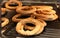 Fresh crusty bread rolls or traditional bagels with sesame seeds on the showcase of the bakery in the supermarket