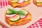 Fresh Cucumber and Radish with Green Onions and Cheese on Crispy Cracker