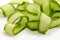 Fresh cucumber ribbon peels on white background