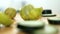 Fresh cucumber slices and halved limes on wooden cutting board