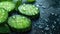 Fresh cucumber slices with water droplets on a dark surface.