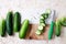 Fresh cucumbers, partly sliced, on chopping board.