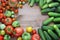 Fresh cucumbers, red and green tomatoes on a table