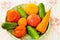 Fresh cucumbers, tomatoes and carrots are laid out on a platter