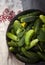 Fresh cucumbers in vintage metal bowl on folksy towel