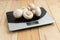 Fresh cultivated button mushrooms on the household digital kitchen scale