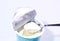 Fresh curd with spoon on opened container