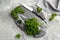 Fresh curly parsley, cutting board and knife on grey table, flat lay