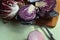 Fresh cut red cabbage on cutting board, red onion, red radicchio