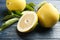 Fresh cut and whole pomelo fruits on blue wooden table, closeup