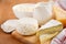 Fresh dairy products. Milk, cheese, brie, camembert and cottage cheese on the wooden background.