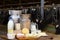 Fresh dairy products on table on background of cows in stall